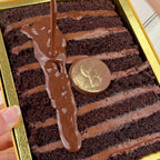 Chocolate Orange ShortStack with a 'GoldBites' logo coin in the center, held by a hand.